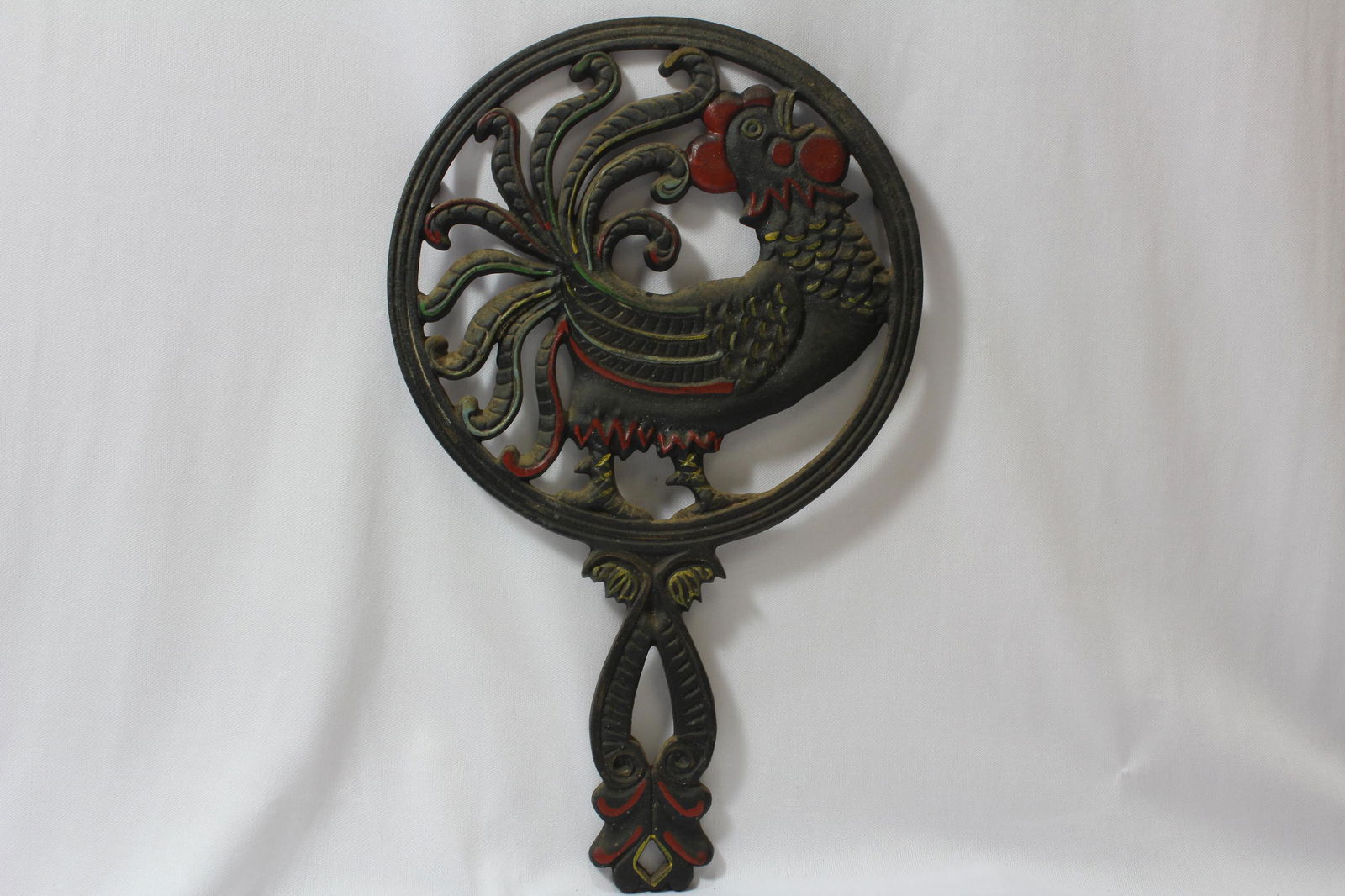 A Cast Iron Trivet: 12 1/8" long, including the handle