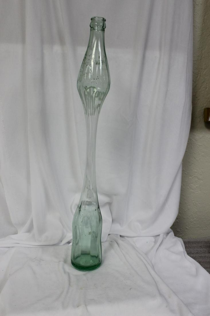 A Long Neck Coca Cola Bottle: 1pt - 19 inches tall