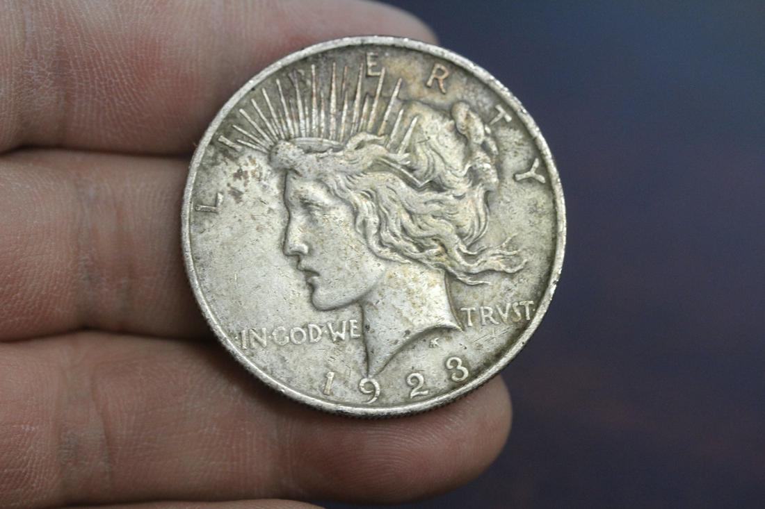 A 1923 Peace Silver Dollar: as shown