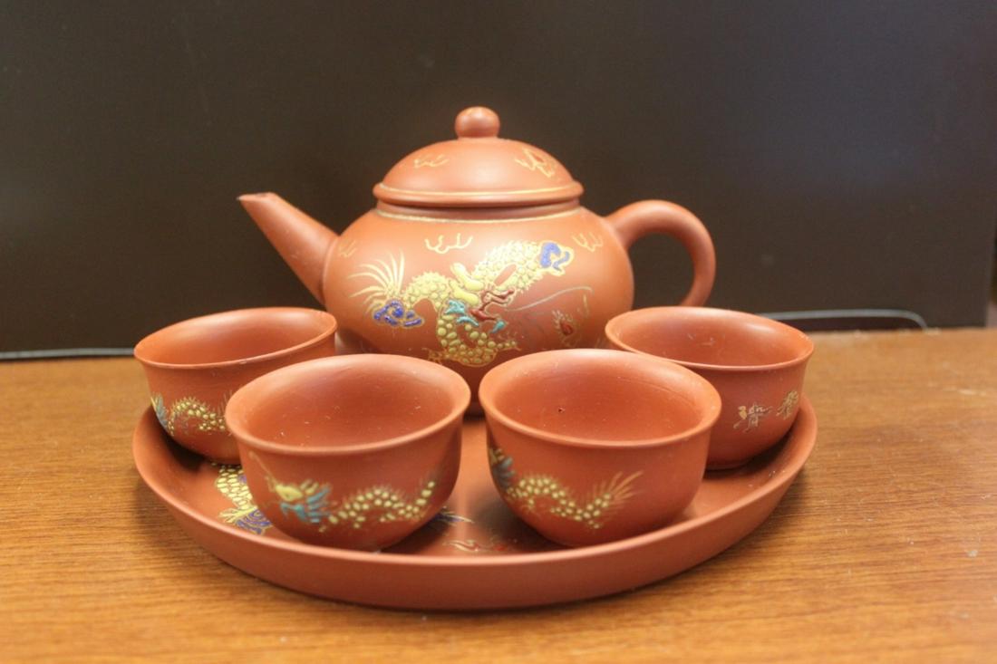 A Chinese Yixing Teapot / Cup Set With Undertray.: 20th Century. Teapot Measures at 6" Wide. Tray Diameter: 7 7/8"