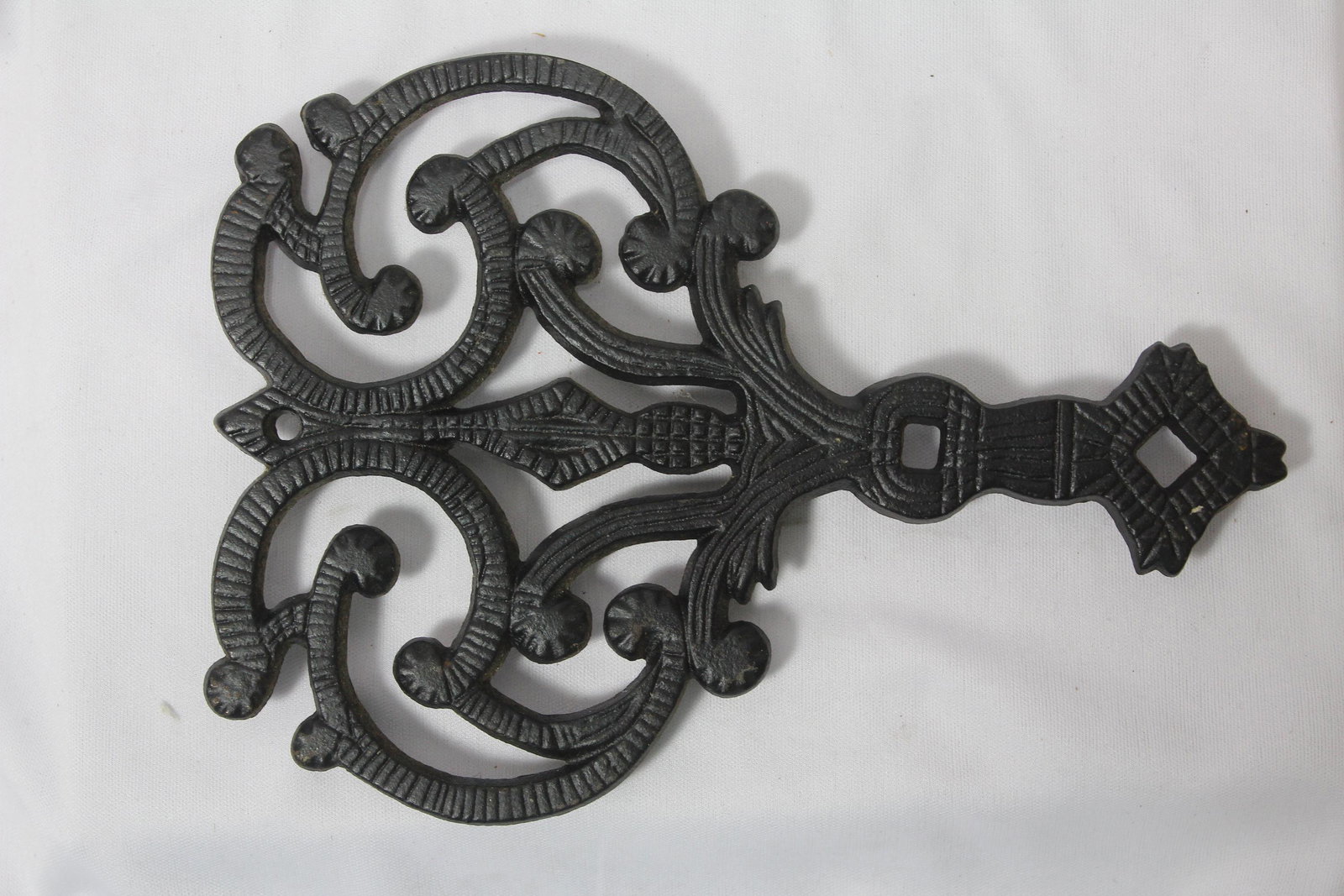A Cast Iron Trivet: 6 1/8" wide