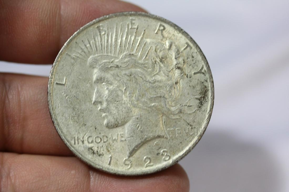 A 1923 Peace Silver Dollar: as shown