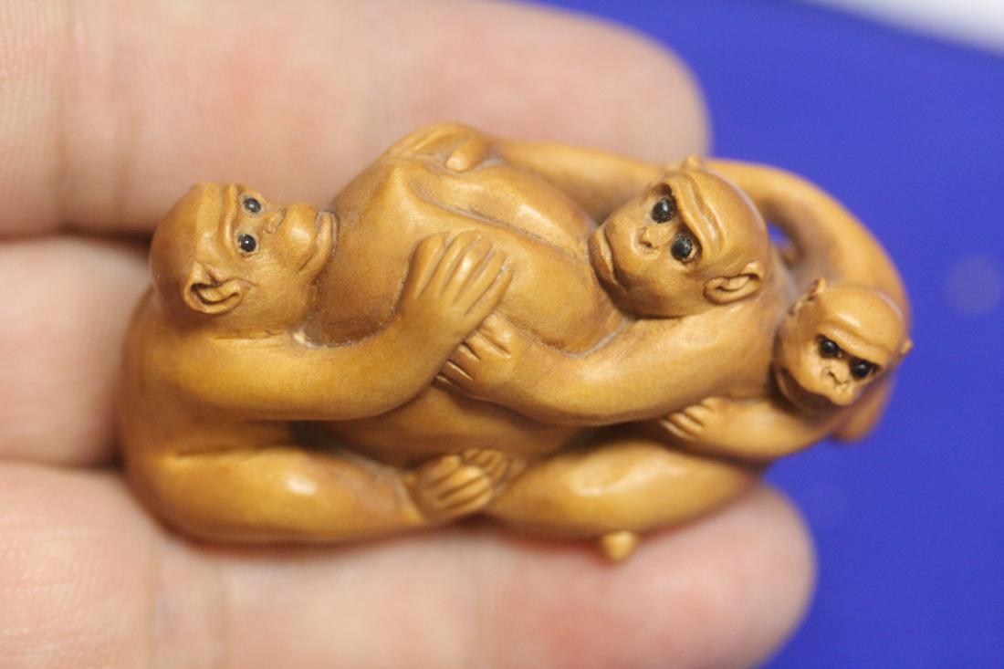A Signed Japanese Carved Wood Netsuke Monkey Group: 2 inches across