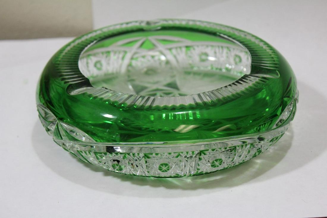 A Green Cutglass Ashtray: please note: a couple of small edged roughness - 6 7/8" in diameter