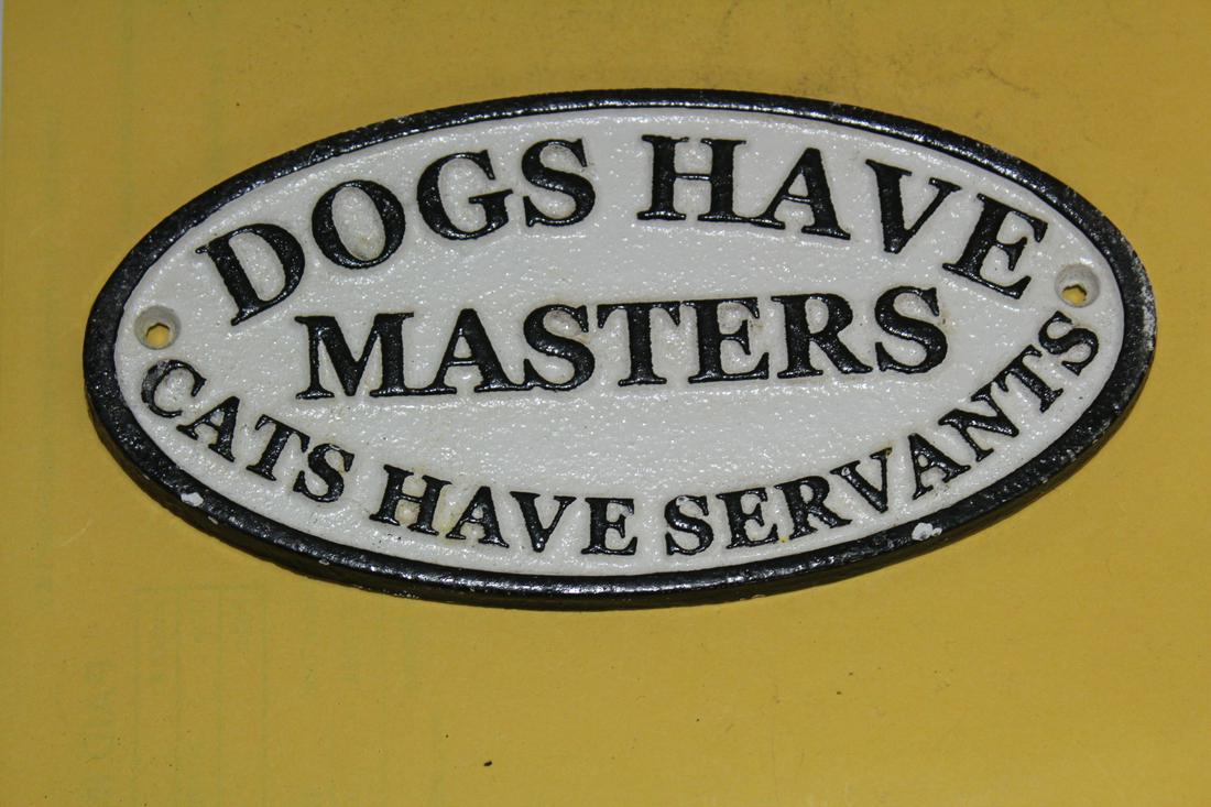 A Cast Iron Cats and Dogs Sign: 7" across