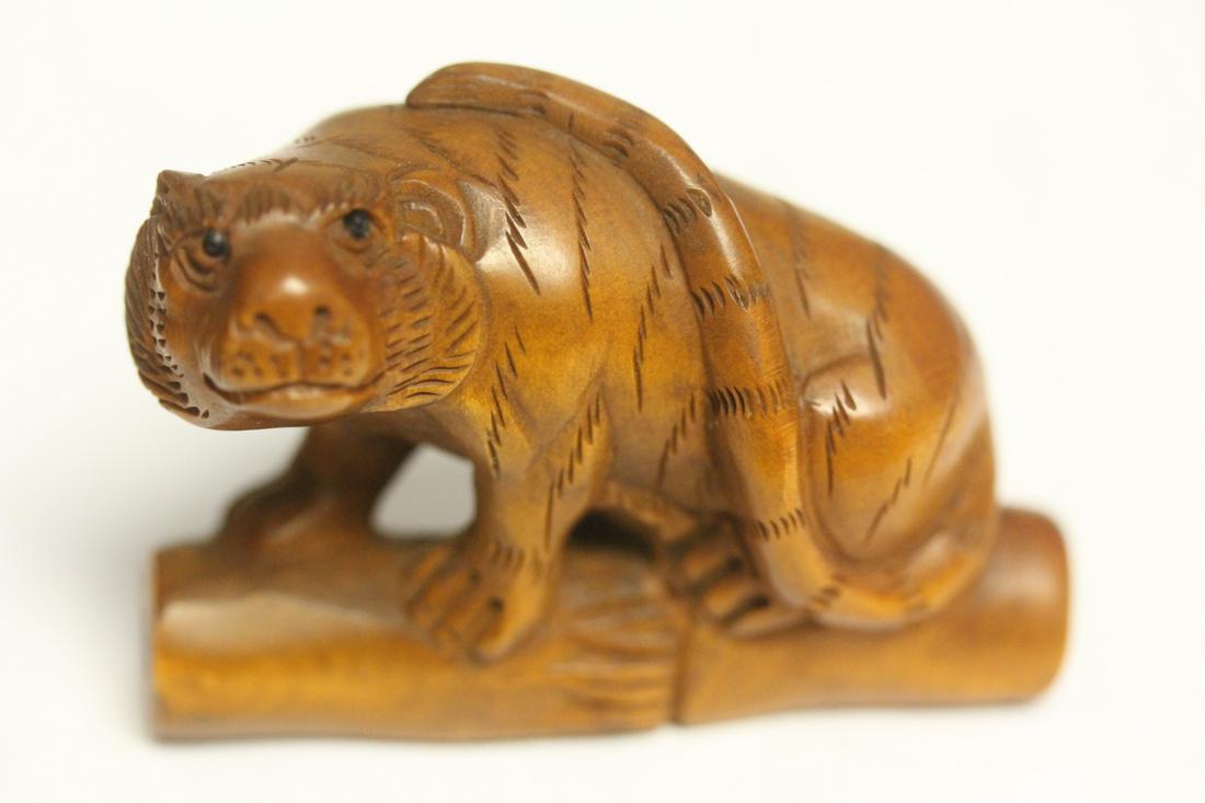 A Japanese Netsuke: boxwood or fruitwood - 2 inches across - signed