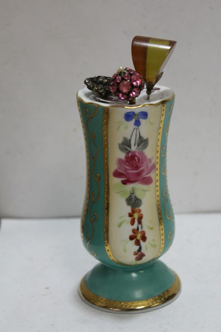 A Nippon Hat Pin Holder: with 3 hat pins - to include a bakelite one - overall= 6 1/2"