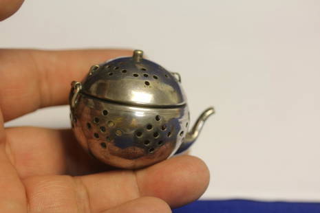 A Sterling Teapot Form Tea Strainer: 1 3/4" wide