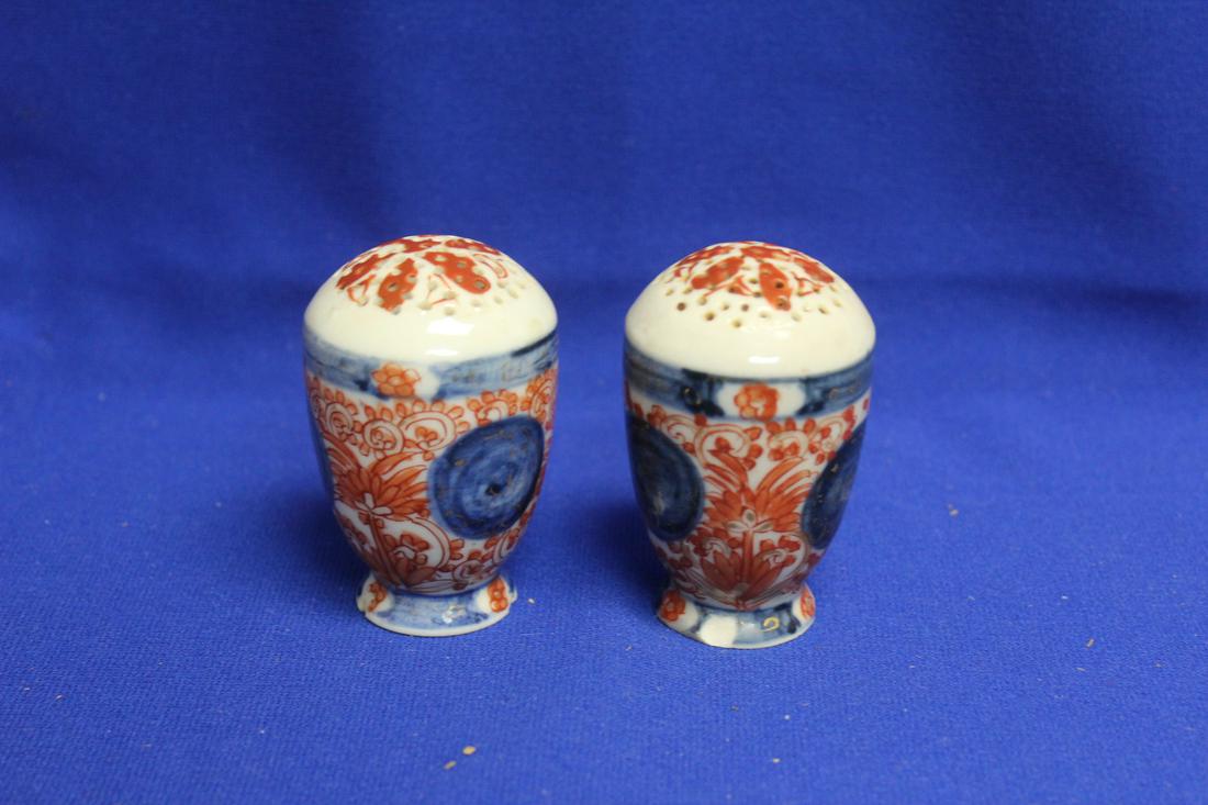 A Pair of Japanese Imari Salt and Pepper Shakers: 19th century - please note: chip on the bottom rim on both shakers as shown - 3 1/4" tall