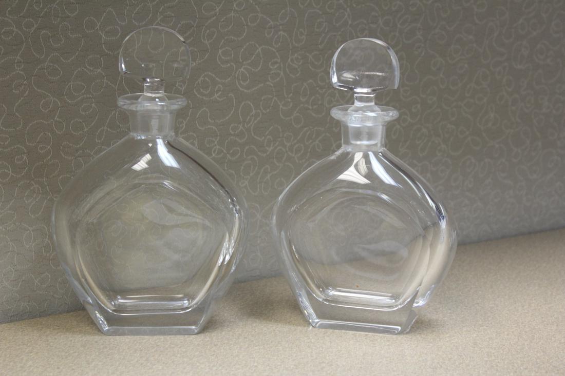 Pair of Signed Orrefors Crystal Decanters: please note: one tip of a decanter has a chip as shown - 8 1/4" tall