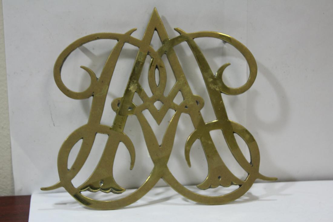 A Vintage Brass Trivet: Williamsburg Queen Anne Cypher - 10 1/2" across