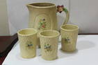 A Japanese Pottery Pitcher and 3 Cups