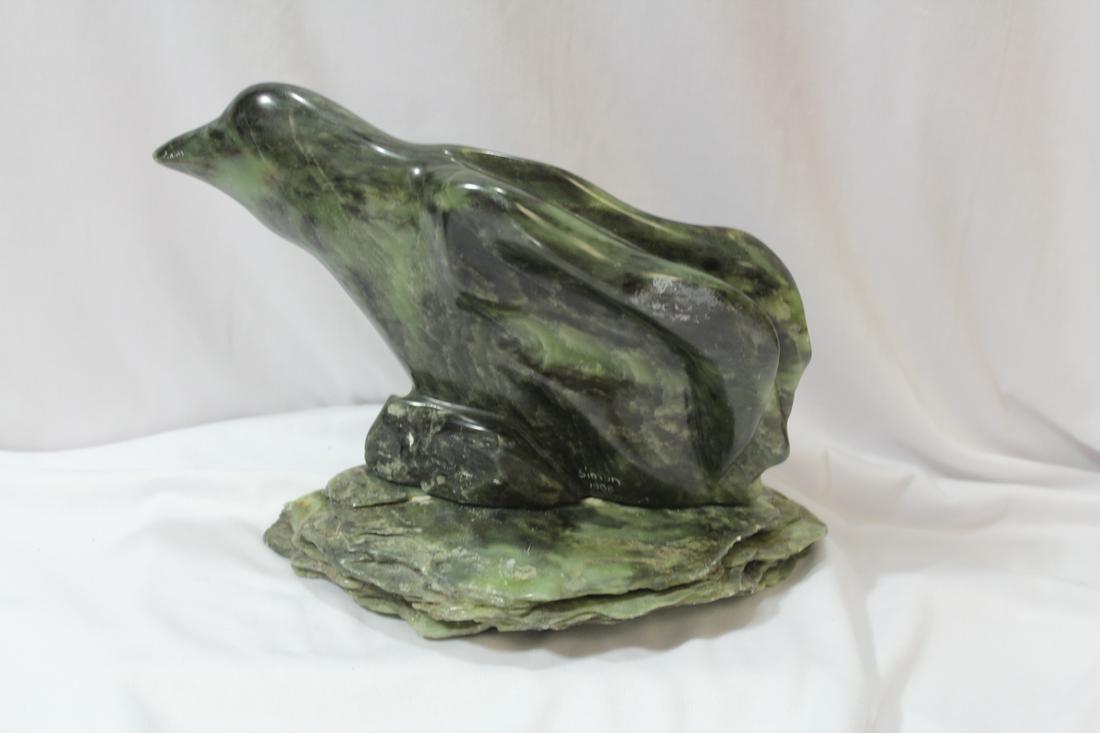 An Alaska Jade or Stone Bird: please note: stone base and bird are two separate pieces as shown - 9 1/4" long - signed: Simon 1008