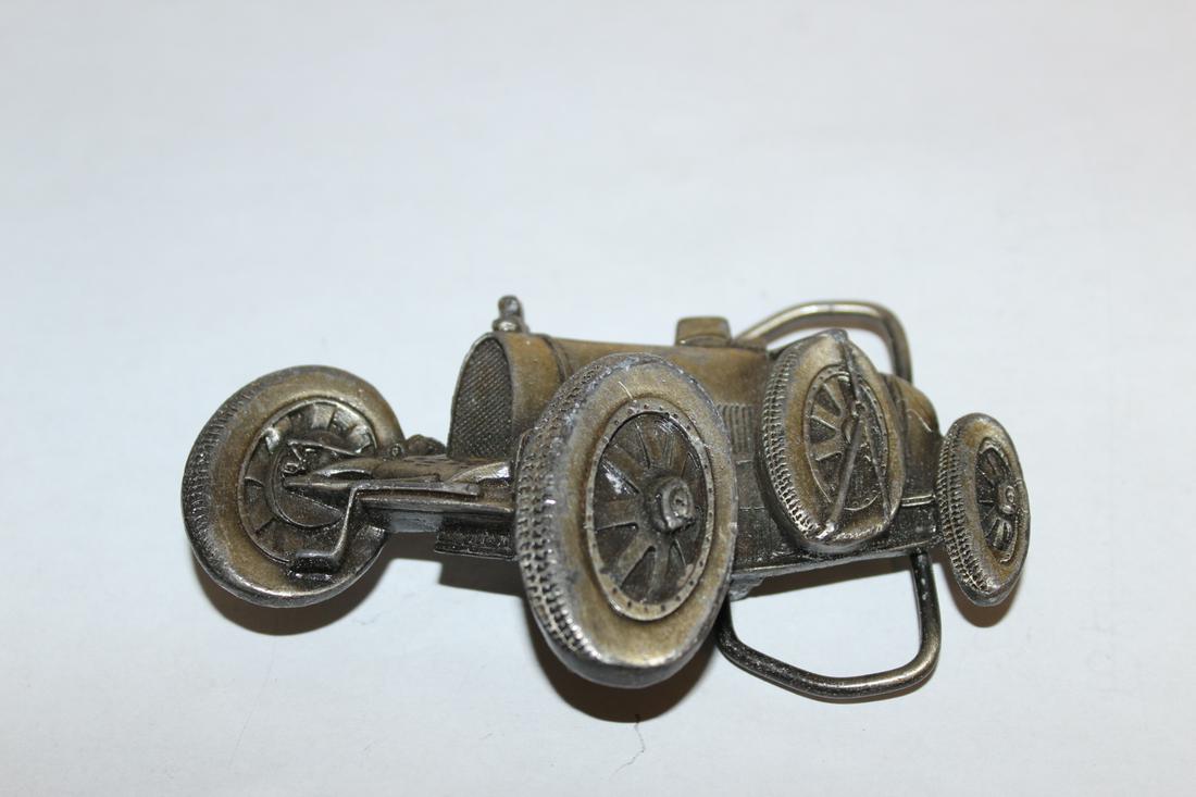A Belt Buckle: in the form of a vehicle - approximately 4 inches wide
