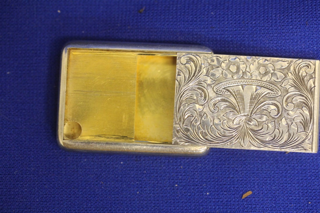 A Well Carved Sterling Pill Box: has some weighted to it - over one ounce - 1 7/8" across