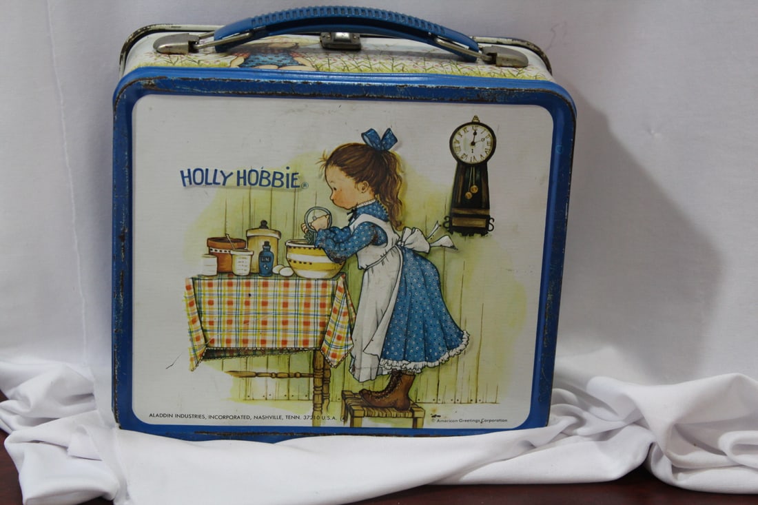 A Holly Hobbie Tin Lunch Box: no thermos - 8" across