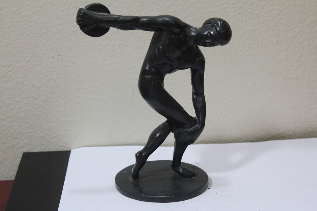 A Disc Thrower: heavy metal, possibly wrought iron - 6 1/4" tall