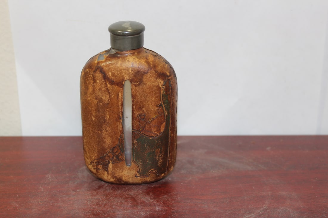 A Leather over Glass Liquor Flask: probably early 1900's - 5 inches tall