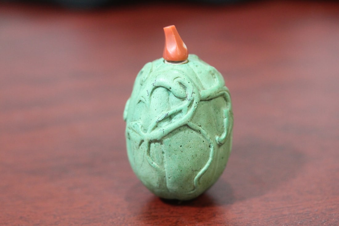 An Antique/Vintage Chinese Torquise Snuff Bottle: carved - melon form - coral top - please note: tip of spoon is detached - 2 inches tall without the spoon