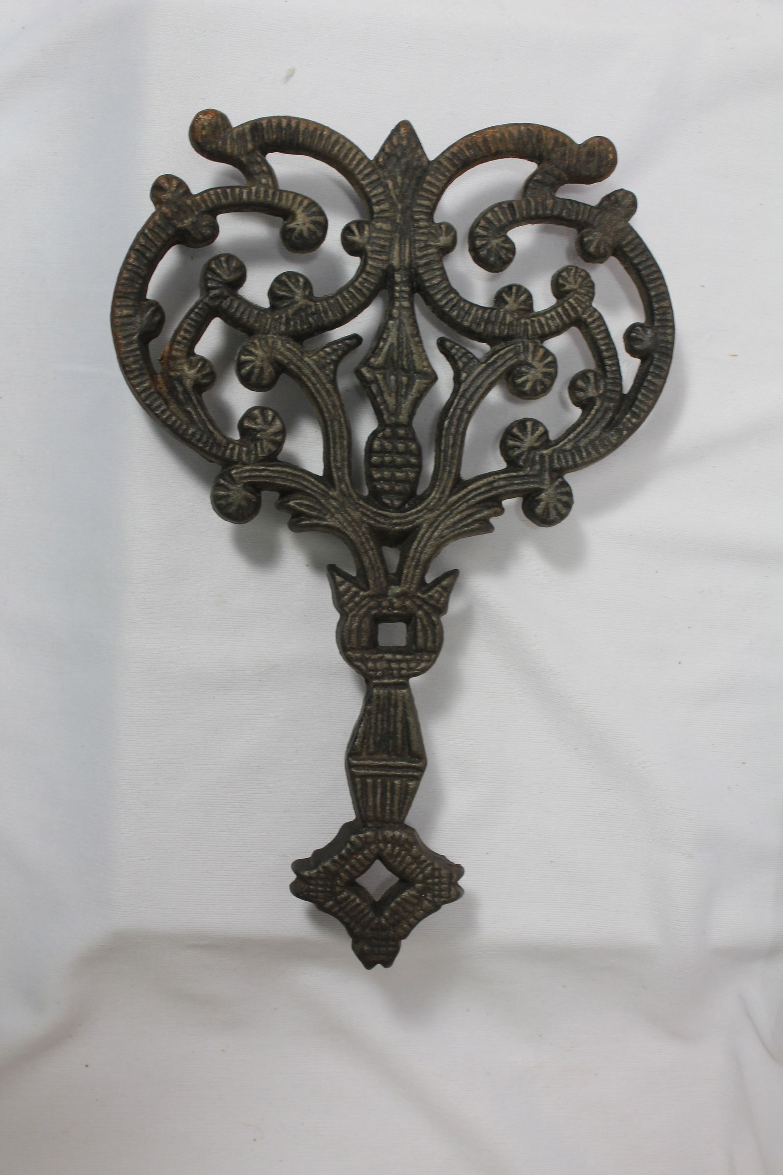 A Wilton Cast Iron Trivet: 6" wide