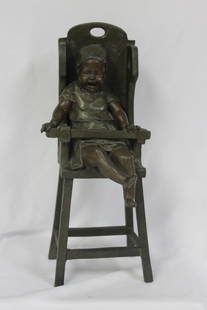 A Bronze Child on a High Chair by Steiner: signed - 13" tall
