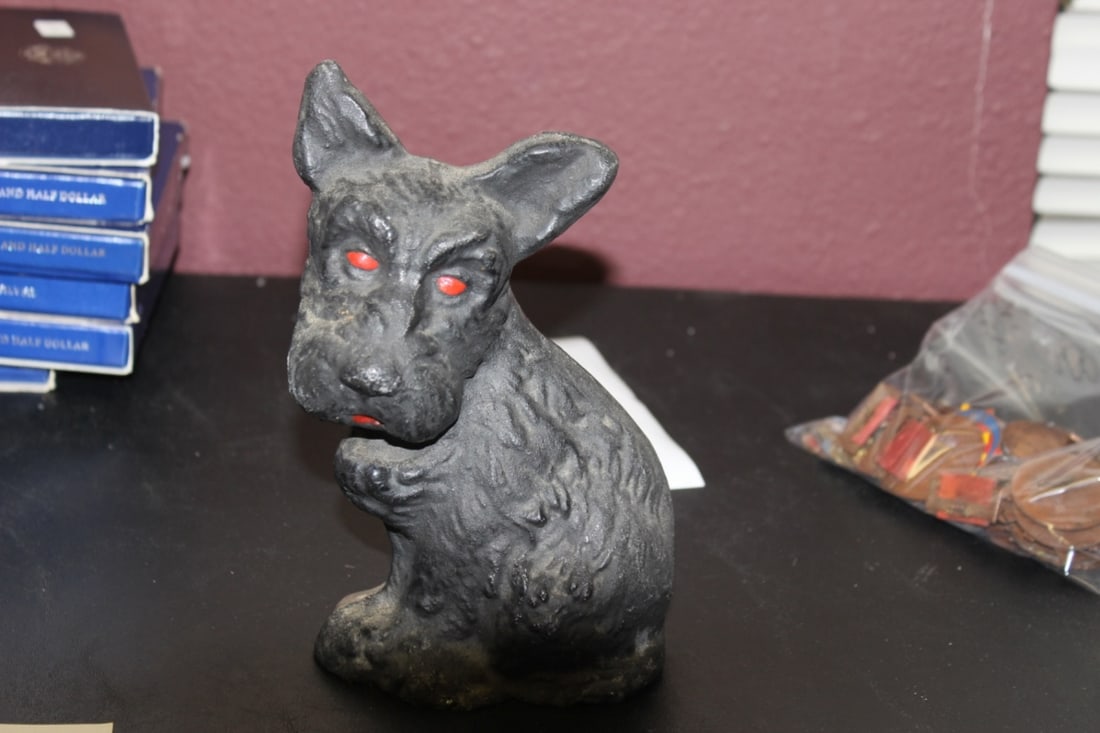 An Antique/Vintage Cast Iron Door Stopper: Depicting a dog with red eyes - makers mark on the back, but cannot see who the manufacturer is - 7 5/8" tall