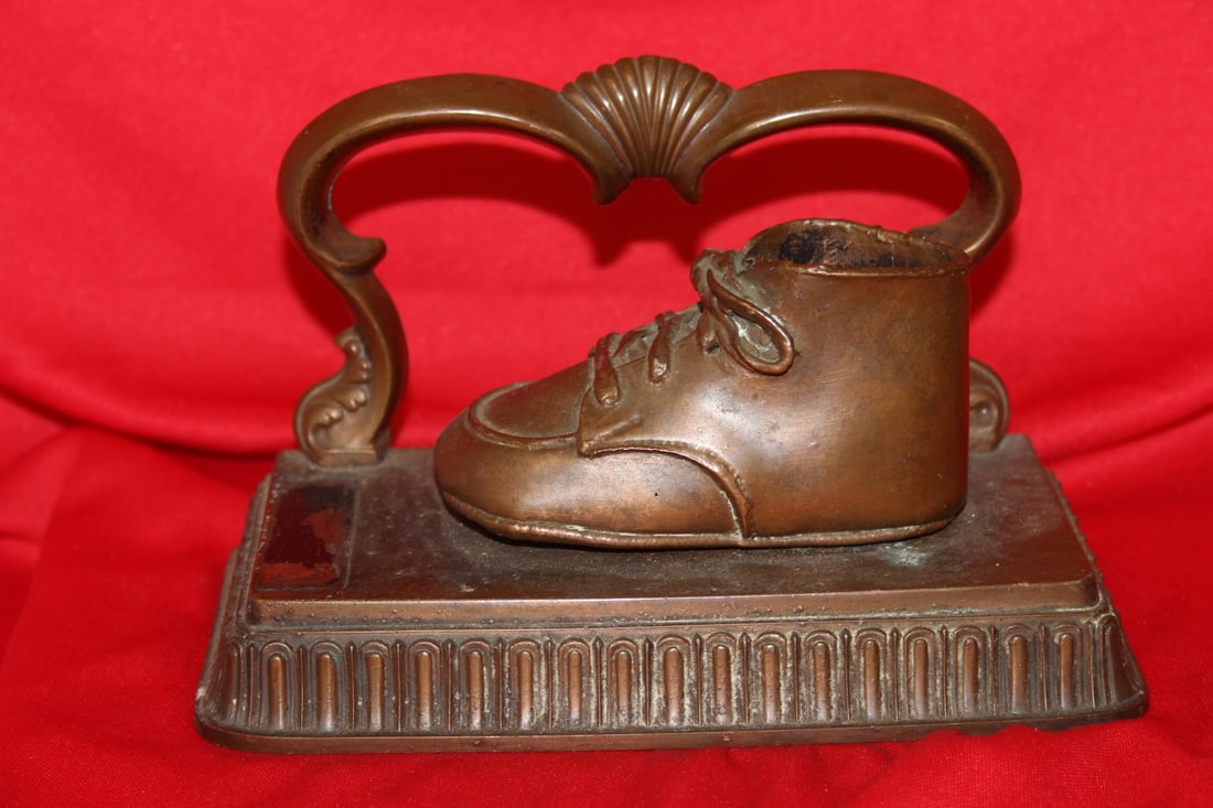 A Bronze or Metal Baby Shoe: 7" across