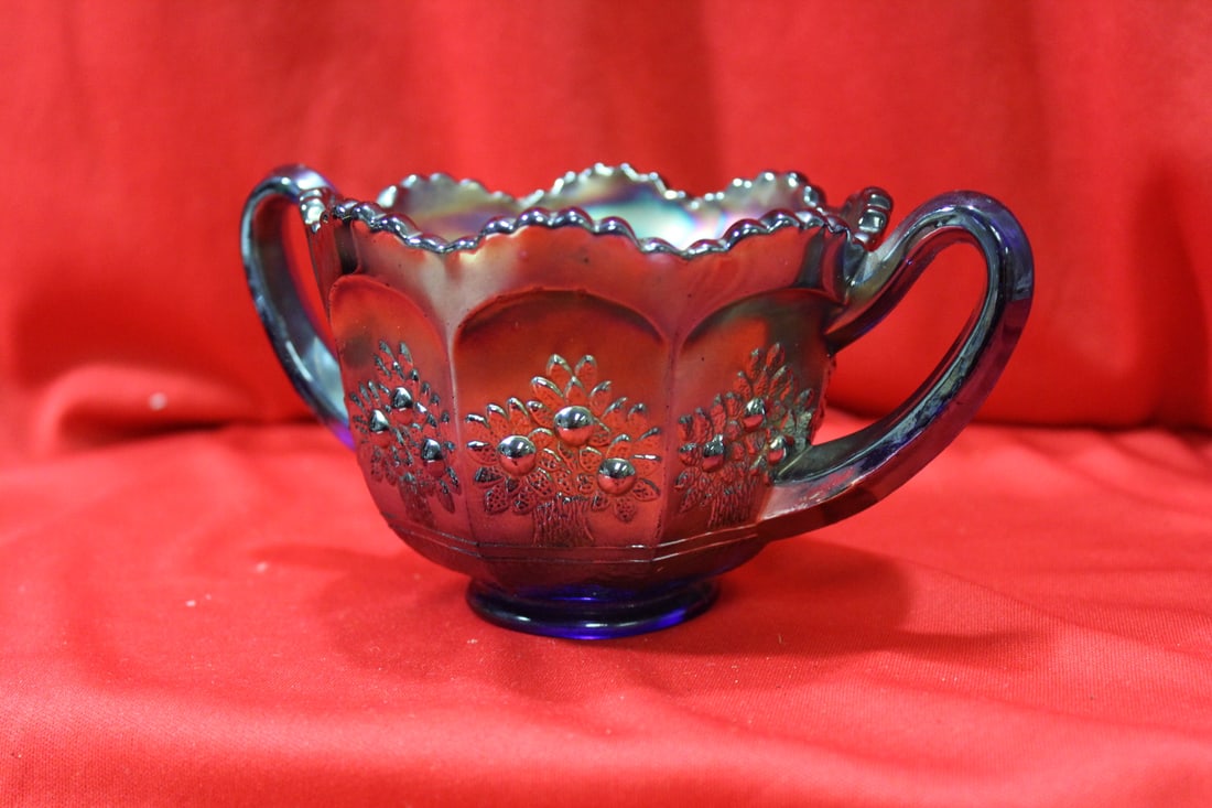 A Carnival Glass Cup: 6 1/2" in diameter from handle to handle