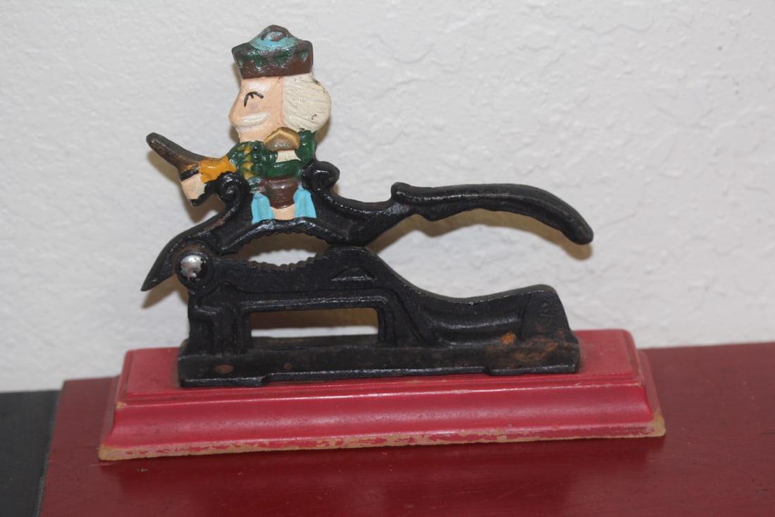 Cast Iron Nut Cracker: on wood - 7 1/2" long