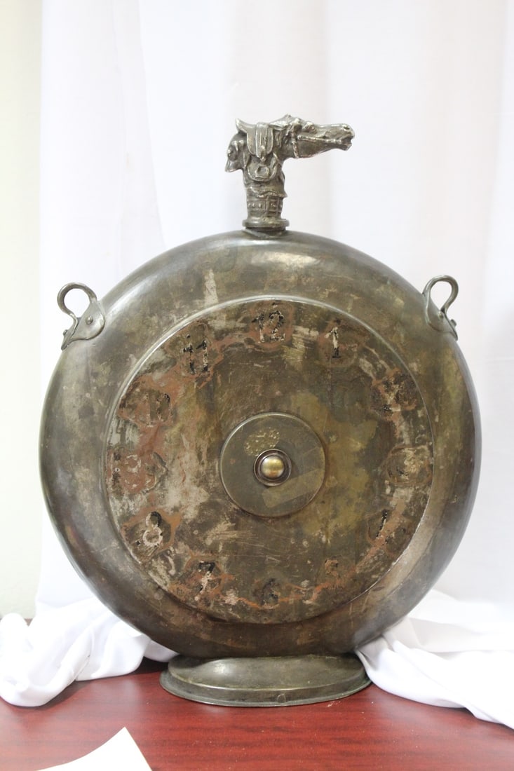 A Large Copper Flask: with horse and dog finial - also appears to have a clock dial face - very unusual - finnial twist open - 15 1/2" tall x 11 1/8" wide