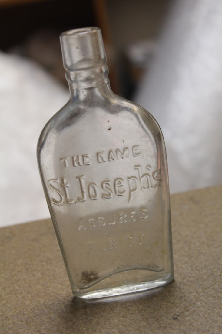 Antique Embossed Cork Bottle: embossed the name St. Joseph's Assures Purity Flask - 5 7/8" tall