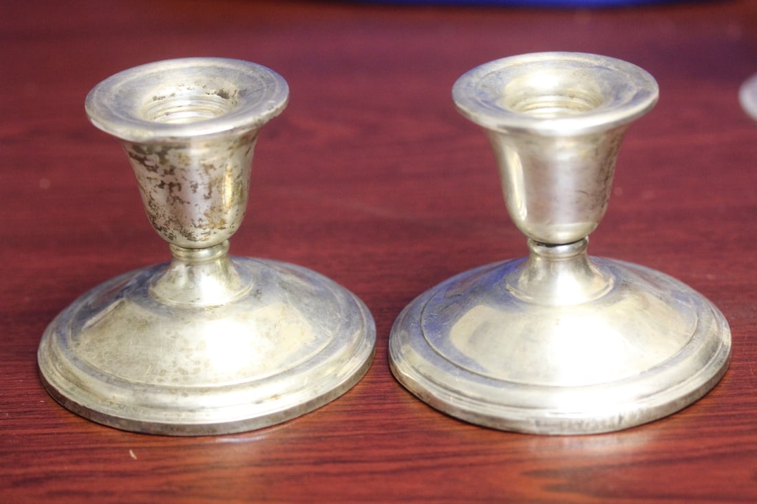 A Pair of International Sterling Candlesticks: weighted - please note: minor rim dents as shown - 3" tall