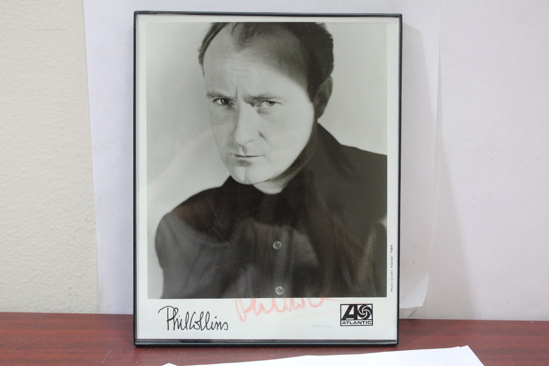 A Signed Phil Collins Print/Poster/Photograph: Framed - overall= 8 1/8" x 10 1/8"