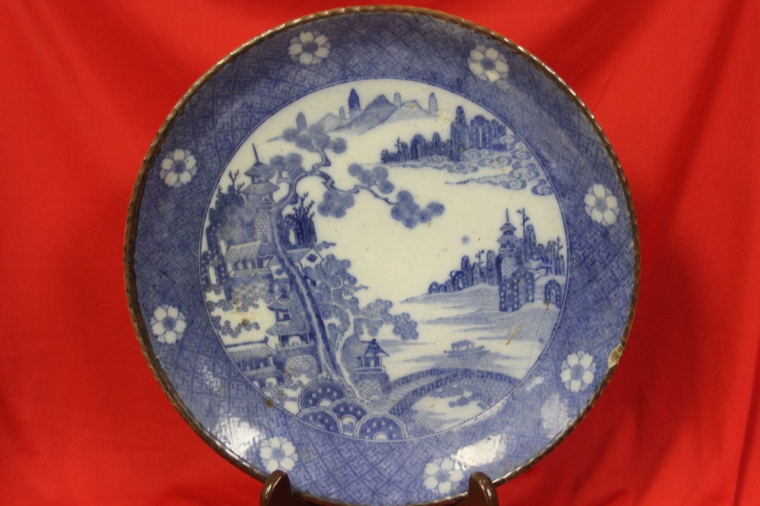 A Japanese Blue and White Porcelain Imari Plate: 12" in diameter - please note: chip as shown