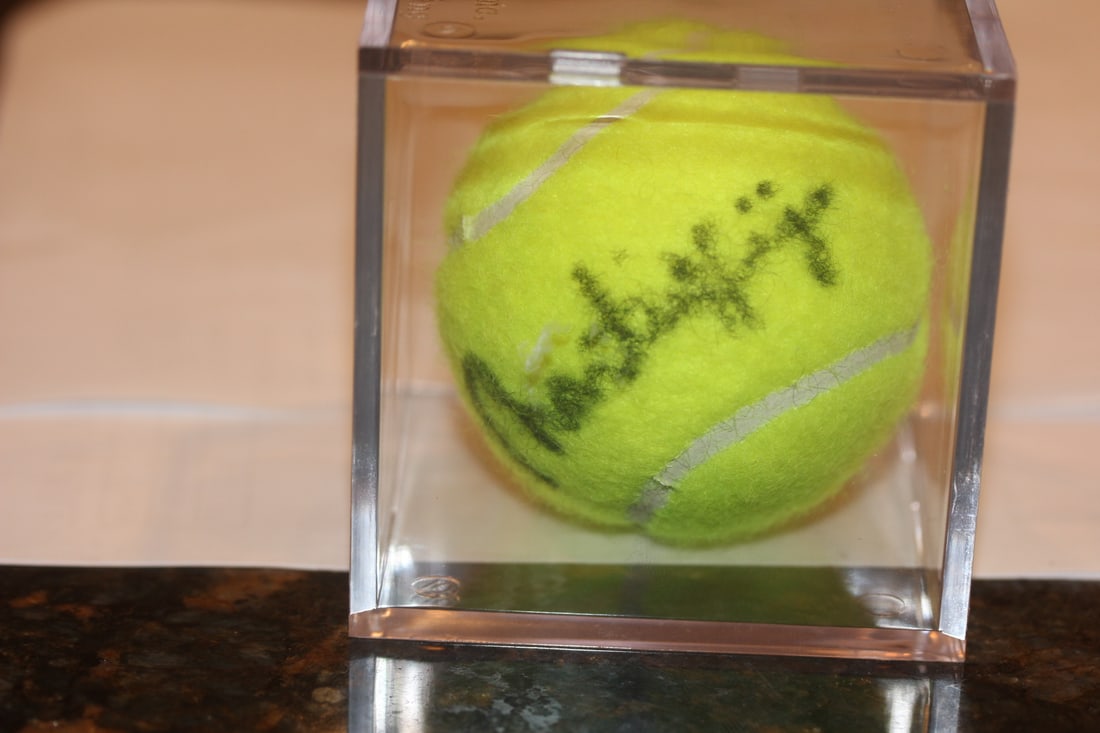 Martina Hingis Signed Tennis Ball: inside a lucite cube