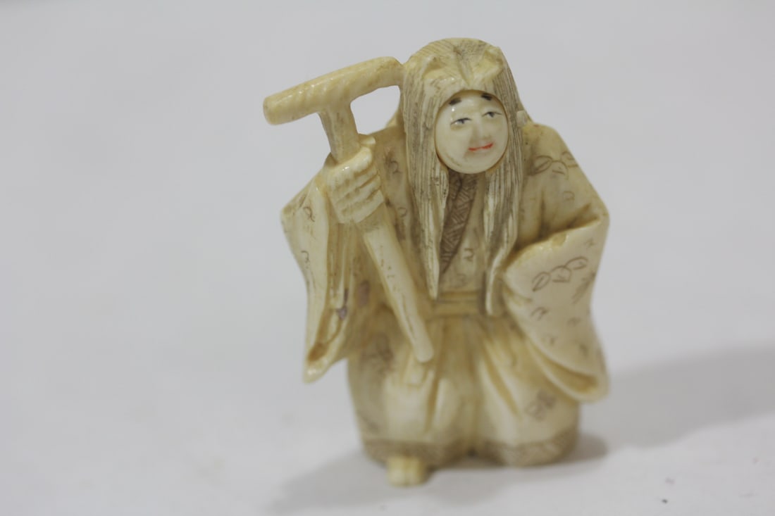 A Japanese Kabuka Dancer: Two rotating faces - bone netsuke - 2 1/8" tall