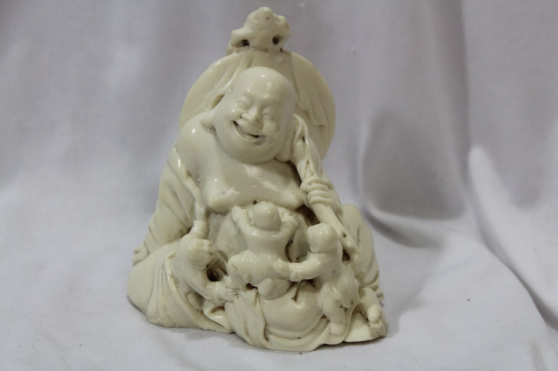 A Well Carved Resin Buddha: with children - 4 5/8" tall