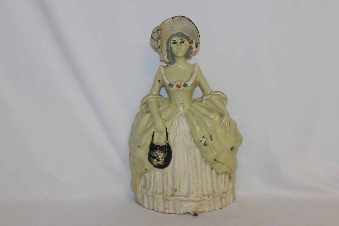 An Antique Cast Iron Lady: Possibly 19th century - 10 3/8" tall
