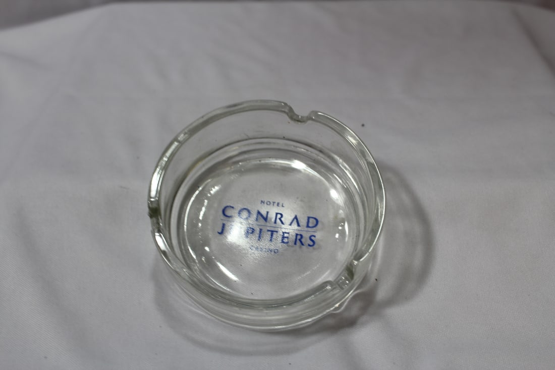 A Glass Advertising Ashtray: Hotel Conrad, Jupiter - 3 1/2" in diameter