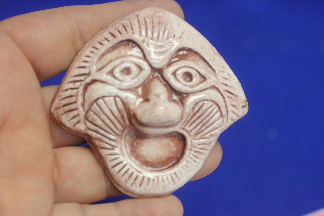 A Ceramic Face: 2 7/8" in diameter