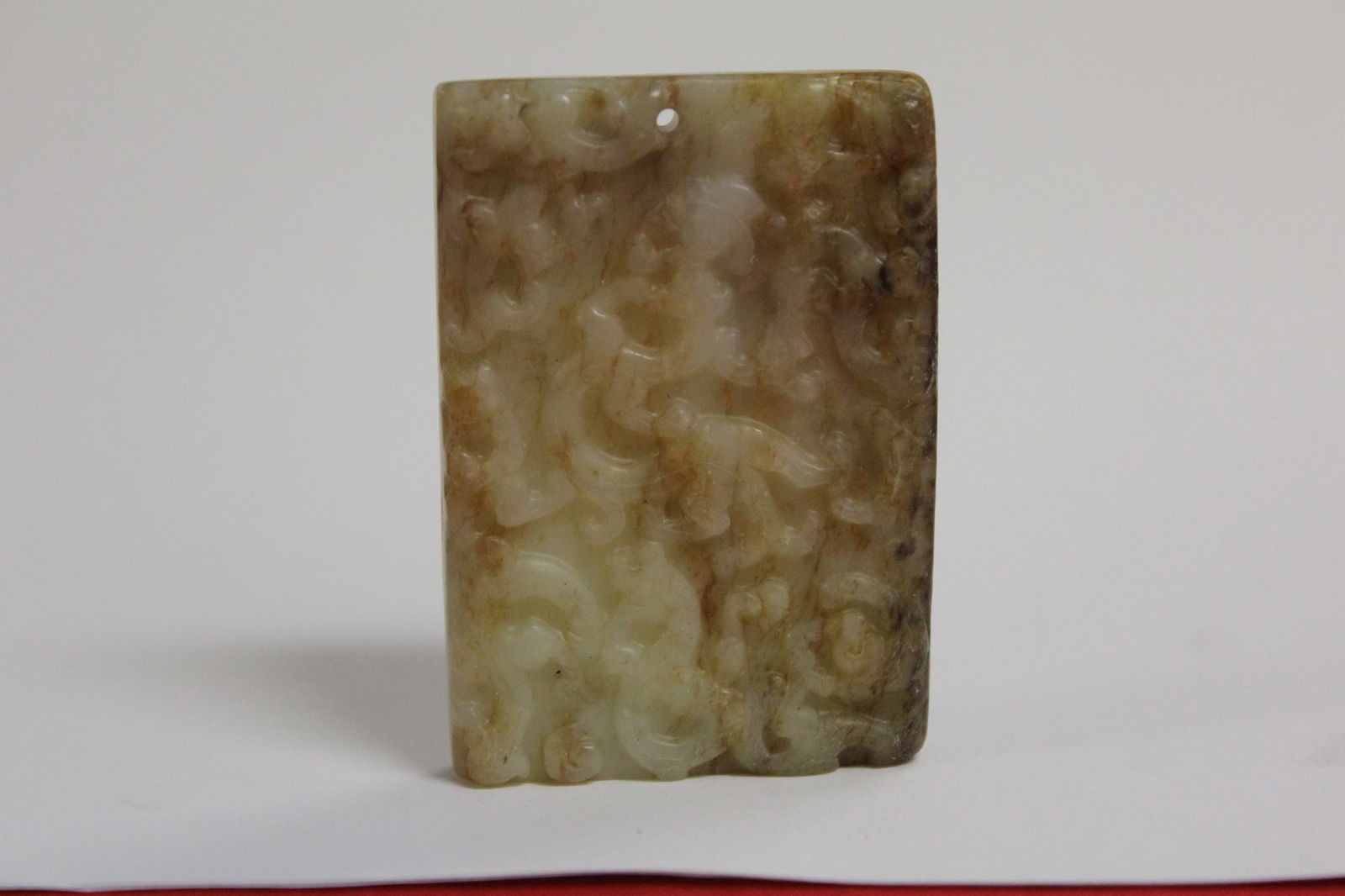 A Russet Jade Plaque: 2 3/4" x 1 3/4" as a pendant