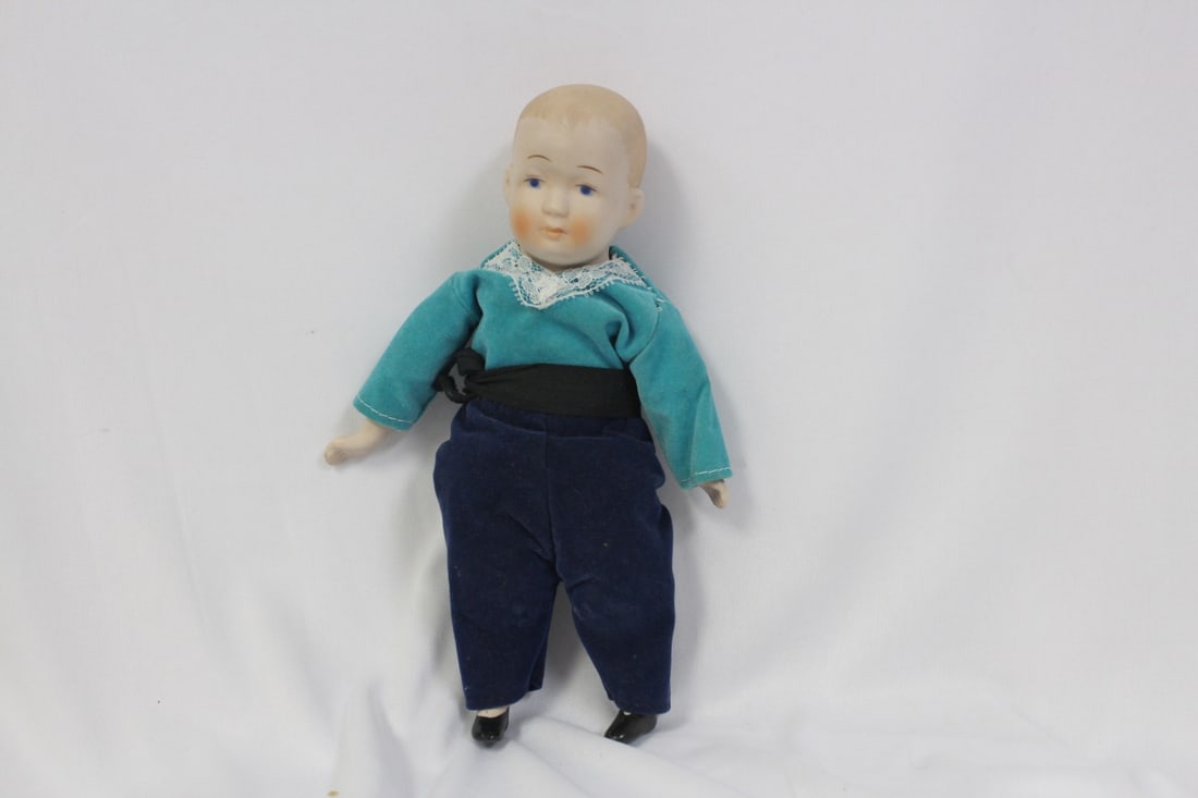 A Porcelain Jointed Doll: 8 3/4" tall