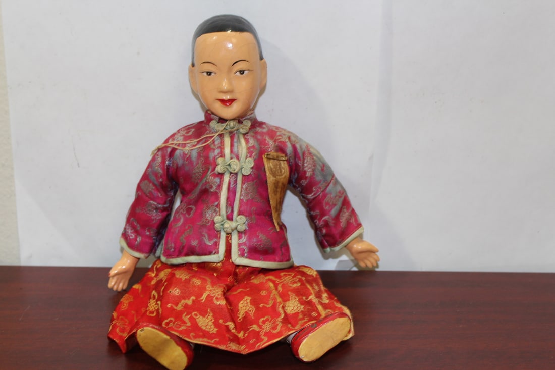 A Vintage Lacquer Doll: made in Hong Kong - with original silk clothing - please note: cannot stand by itself - cloth is worn - 10 3/4" tall