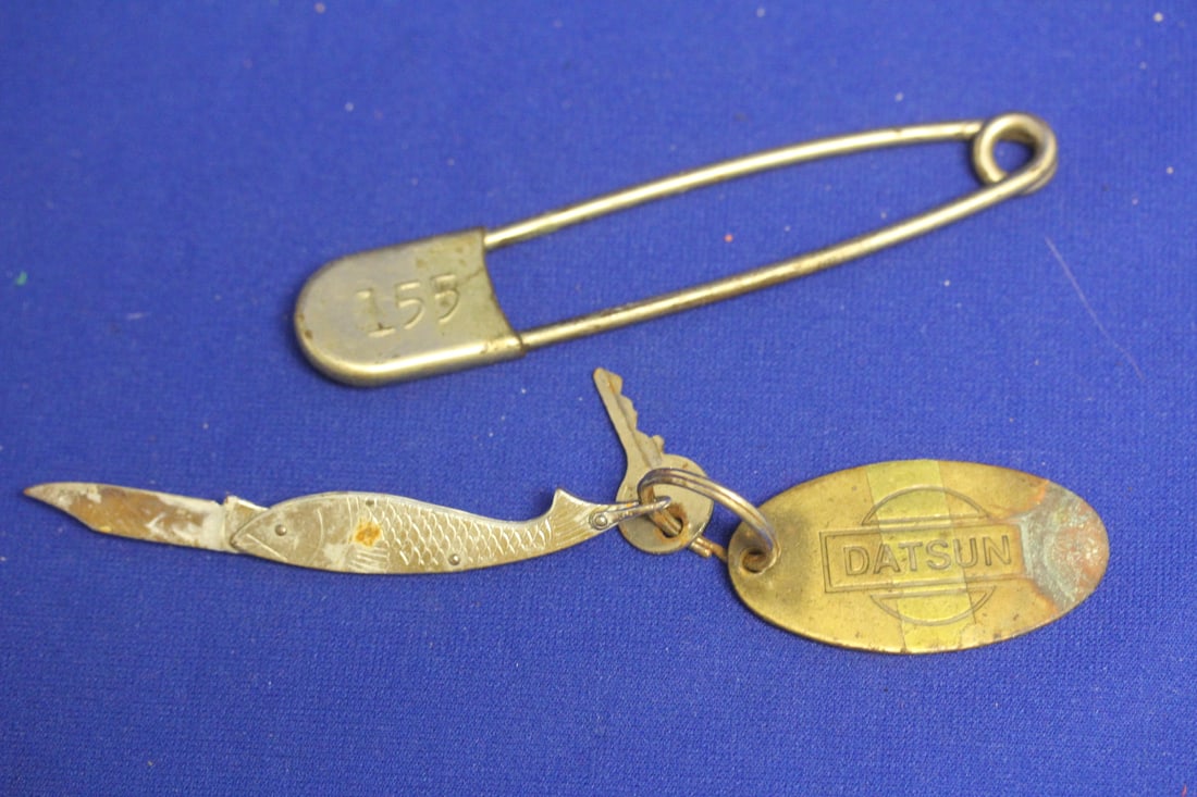 Lot of 2 Articles: to include a large clothes pin and a Datsun keychain with fish knife