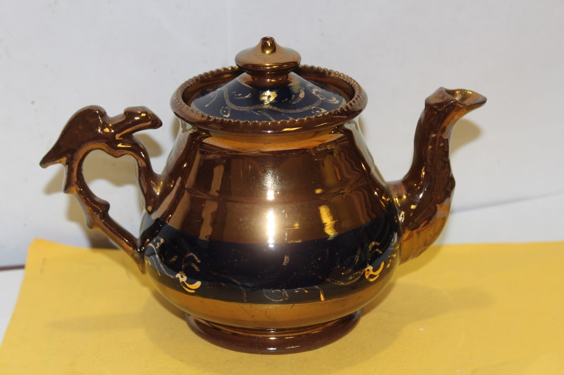 A Ceramic Lusterware Teapot: 7" across