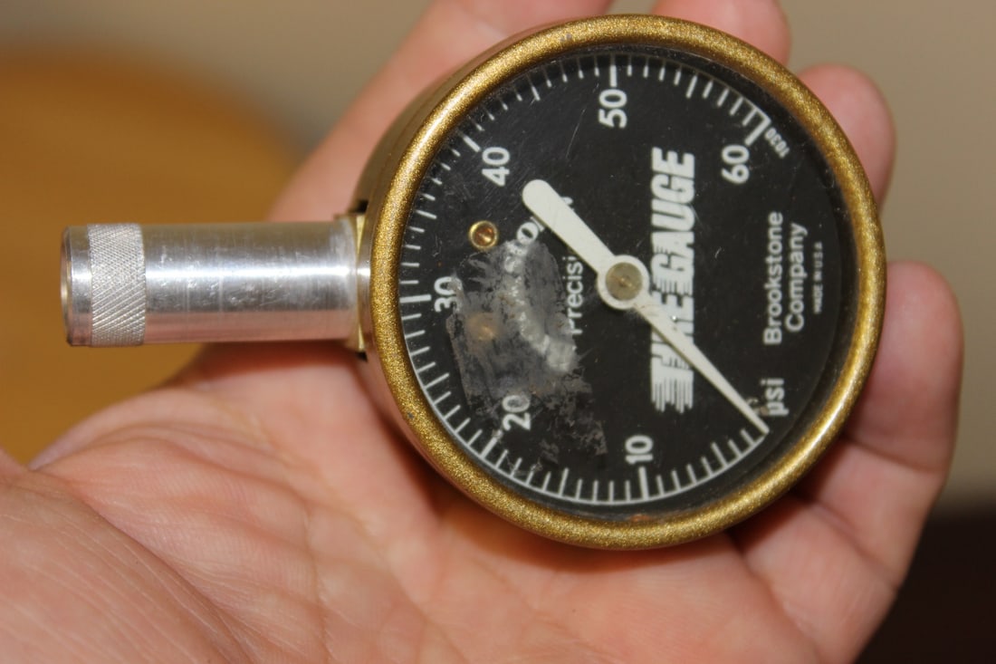 A Brookstone Company Tire Gauge: as shown