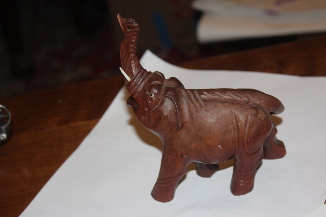 Wooden Elephant: trunk up - please note: chip on one tooth as shown - 5" across