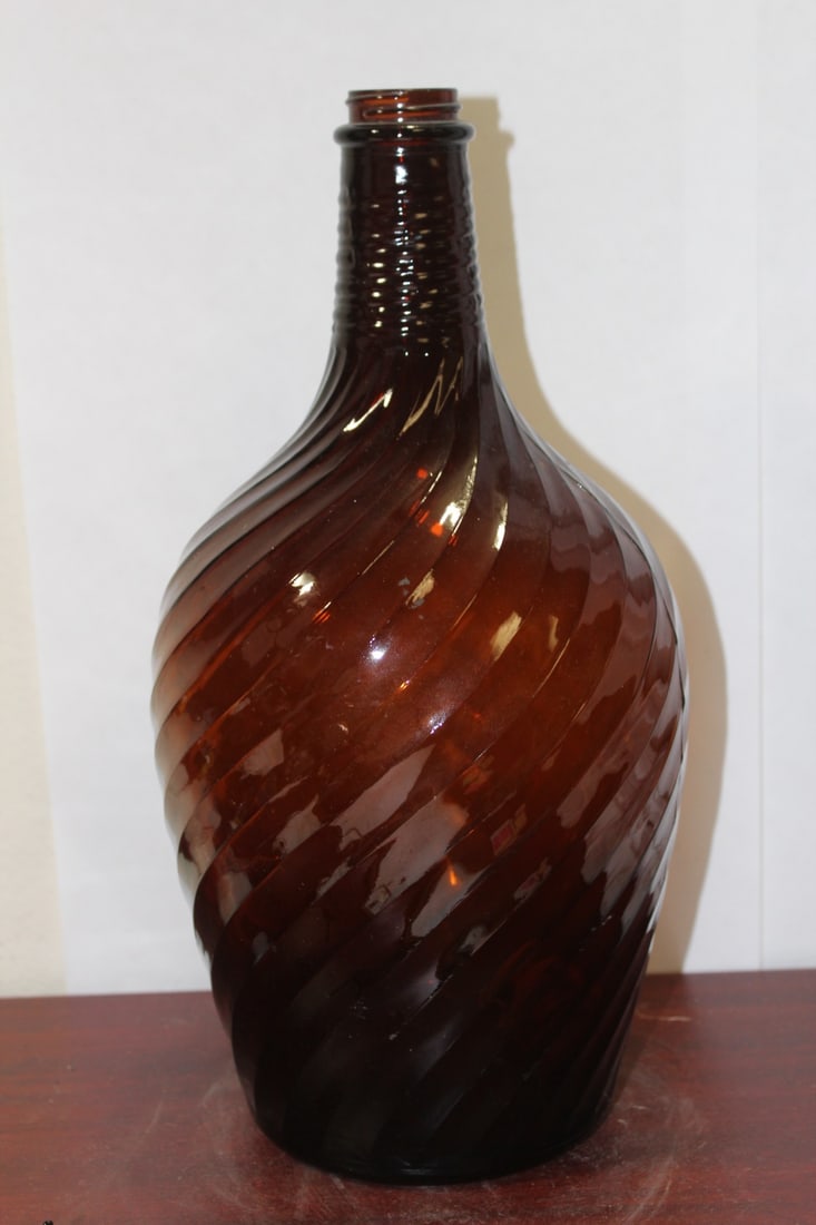 An Amber Glass Spirit Bottle: swirl design - 13 1/2" tall