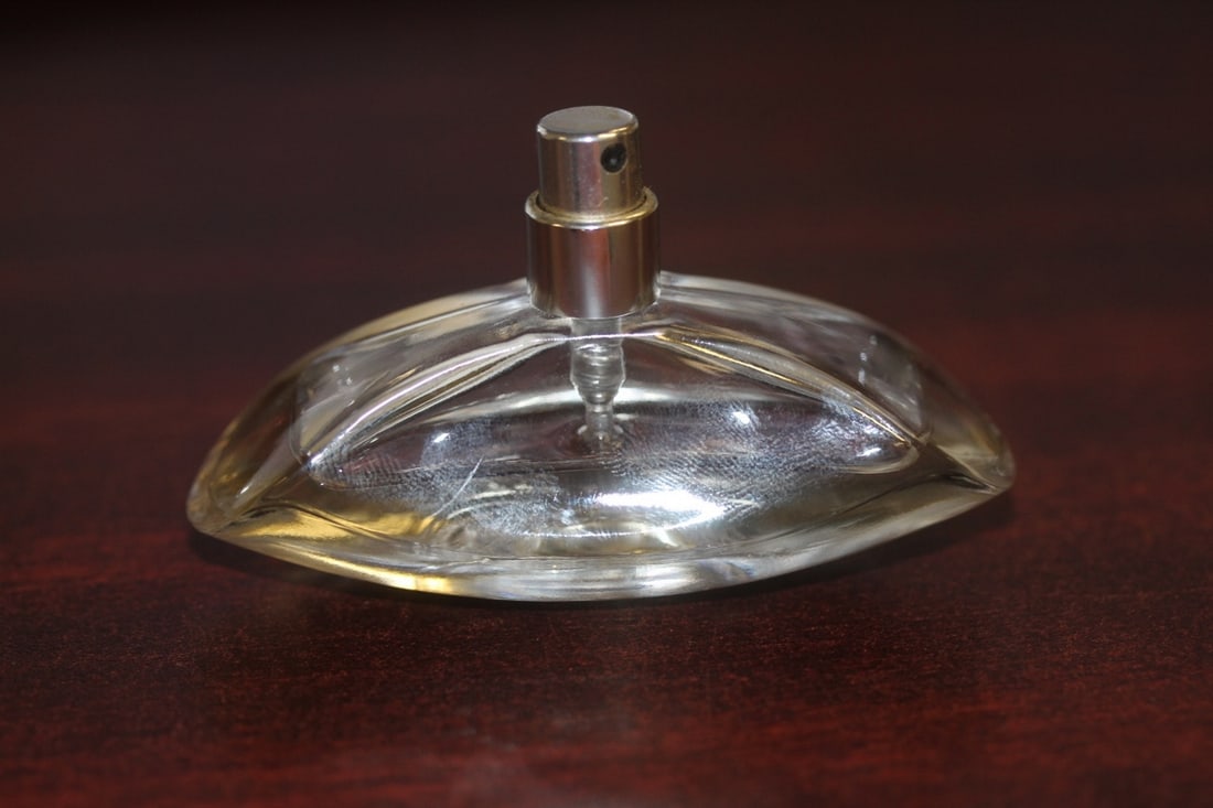 A Small Parfume Spray: over half full - some parfume inside - brand unknown