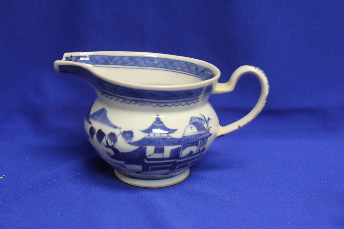 An Antique Blue and White Canton Creamer: please note: handle is restored - 19th century - approximately 7" across from handle to spout